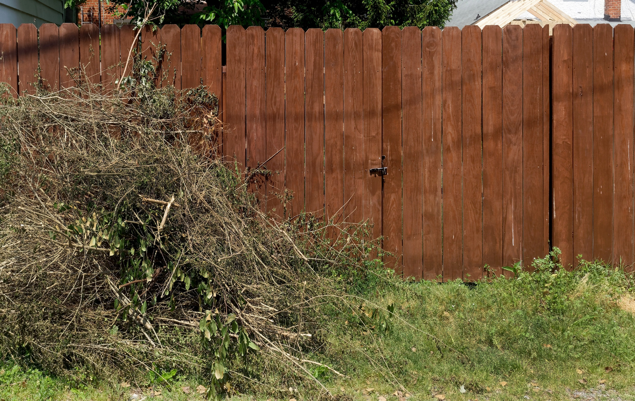Yard Debris Against Fence